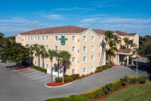 an aerial view of a hotel with palm trees at Homewood Suites by Hilton Bonita Springs, FL in Bonita Springs