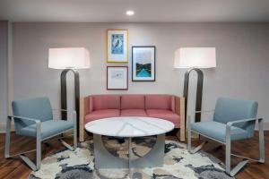 a waiting room with a couch and two chairs and a table at Homewood Suites by Hilton Bonita Springs, FL in Bonita Springs