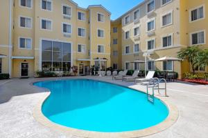 a pool in the courtyard of a apartment building at Homewood Suites by Hilton Bonita Springs, FL in Bonita Springs