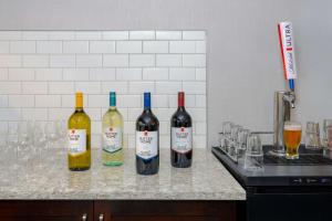 a group of three bottles of wine sitting on a counter at Homewood Suites by Hilton Bonita Springs, FL in Bonita Springs