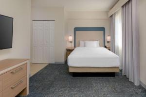 a hotel room with a bed and a tv at Homewood Suites by Hilton Bonita Springs, FL in Bonita Springs
