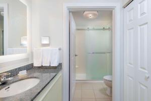 a bathroom with a sink and a toilet at Homewood Suites by Hilton Bonita Springs, FL in Bonita Springs