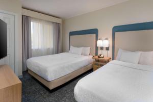 a hotel room with two beds and a television at Homewood Suites by Hilton Bonita Springs, FL in Bonita Springs