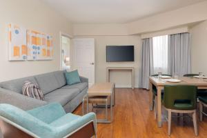 a living room with a couch and a table at Homewood Suites by Hilton Bonita Springs, FL in Bonita Springs