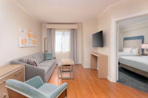 a living room with a couch and a bed at Homewood Suites by Hilton Bonita Springs, FL in Bonita Springs