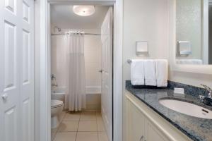 a bathroom with a sink and a toilet and a shower at Homewood Suites by Hilton Bonita Springs, FL in Bonita Springs