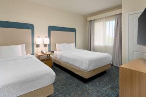 a hotel room with two beds and a window at Homewood Suites by Hilton Bonita Springs, FL in Bonita Springs