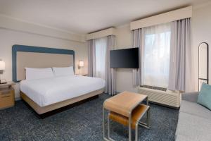 a hotel room with a bed and a tv at Homewood Suites by Hilton Bonita Springs, FL in Bonita Springs
