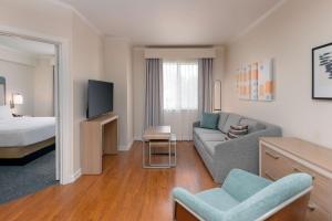 a living room with a couch and a bed at Homewood Suites by Hilton Bonita Springs, FL in Bonita Springs