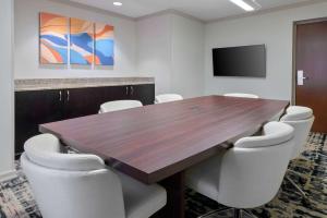 a conference room with a wooden table and chairs at Homewood Suites by Hilton Bonita Springs, FL in Bonita Springs