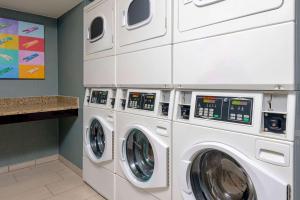 a laundry room with two washer and dryer at Homewood Suites by Hilton Bonita Springs, FL in Bonita Springs