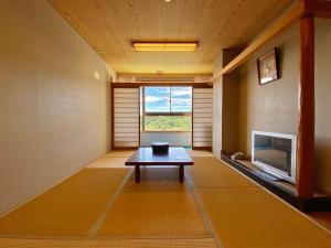 a room with a table in front of a window at くろ潮 in Kitaminato