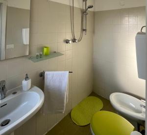 a bathroom with a sink and a green stool at Villa Gennari vista mare in Gradara +16 photos