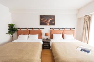 Postel nebo postele na pokoji v ubytování b&天下茶屋店