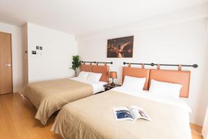 Postel nebo postele na pokoji v ubytování b&天下茶屋店