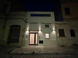 a large white building with a door at night at A Volte nel Salento-Porta Napoli in Lecce