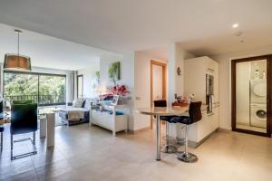 a kitchen and living room with a table and chairs at Samara Resort Gym Spa Jacuzzi Pools in Marbella in Marbella