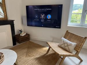 a living room with a flat screen tv on the wall at Loft de Babolène in Villefranche-de-Rouergue +5 photos