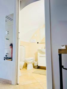 a bathroom with a toilet and a sink at Casa Cassiopea Céglie Messapica in Ceglie Messapica