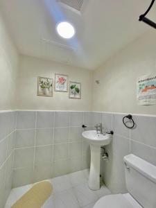 a bathroom with a sink and a toilet at Affordable Staycation near Airport and beach in Suba