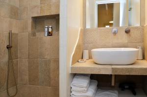 a bathroom with a sink and a shower at Sohoro in Koufonisia +37 photos