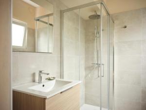 a bathroom with a sink and a shower at Appartamento BACCO in Feriolo +3 photos