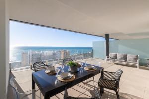 a dining room with a table and chairs on a balcony at Begoña Sea View in Fuengirola