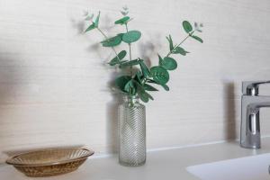 a vase with a plant sitting on top of a sink at Begoña Sea View in Fuengirola +31 photos