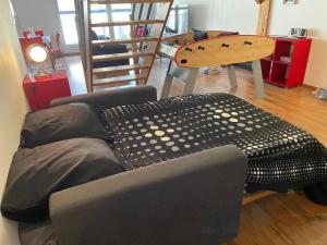 a living room with a couch and a table at Le Kassin in Tallard