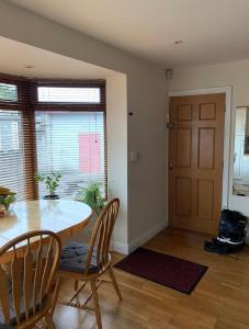 a dining room with a table and chairs and a door at lovely bedroom in Newbridge in Newbridge