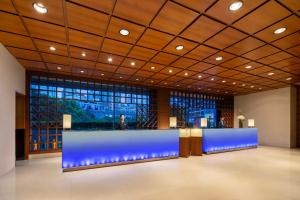 a lobby with a blue counter in a building at Radisson Collection Hyland Shanghai in Shanghai