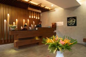 two men sitting at a reception desk in a lobby at Tinton Adventure Resort in Golikatte +37 photos