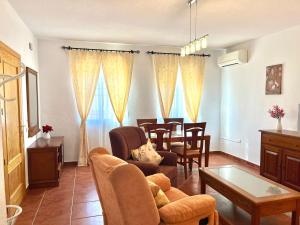 a living room with a couch and a table at Alojamiento Casa Tía Mari in El Robledo +14 photos