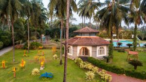 a small house in a park with a playground at Tinton Adventure Resort in Golikatte