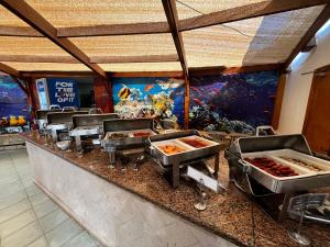 a buffet in a restaurant with a fish mural at Sheraton Soma Bay Resort in Hurghada