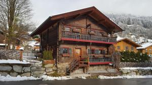 a log cabin in the snow with a balcony at Almliesl PIES-458 in Piesendorf