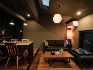 a living room with a couch and a table at SKY KYOTO in Kyoto