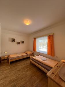 a room with two beds and a window at Penzion Star Doksy in Doksy +42 photos