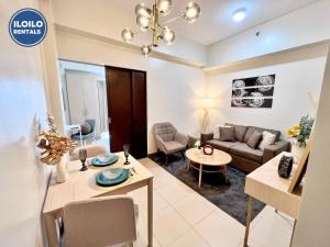 a living room with a couch and a table at Experience Elegance at Chambre Honore in Iloilo City
