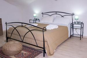 a bedroom with a large bed with two night stands at Vecchia Napoli apt 20 in Naples