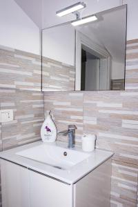 a bathroom with a sink and a mirror at Vecchia Napoli apt 20 in Naples +22 photos