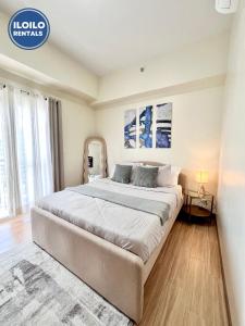 a bedroom with a large bed in a room at Experience Elegance at Chambre Honore in Iloilo City