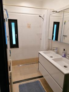 a white bathroom with a sink and a shower at Ferienhaus Berganker in Willingen in Willingen