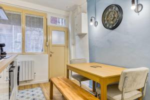 a kitchen and dining room with a wooden table and chairs at Loulou maison de ville sur 4 niveaux au coeur de ville in Rouen +37 photos