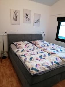 a bed with a quilt on it in a room at Ferienhaus Berganker in Willingen in Willingen