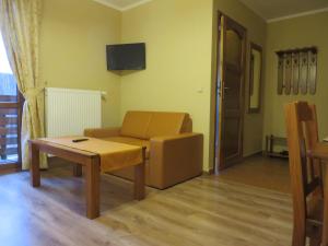 a living room with a couch and a table at Chata Sudecka in Sienna