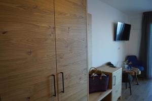 a large wooden cabinet in a room with a desk at Gasthof Videgg in Schenna