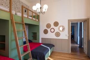 a bedroom with a bunk bed and a ladder at Casa Felice - Villa con Giardino in Centro in Verbania