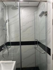 a glass shower in a bathroom with a sink at HT Home D'el Dorado 4 in Hanoi