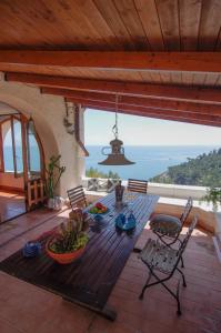 a table on a deck with a view of the ocean at NSM Villa Carlotta E Villa Guarda che Mare in Vieste - Gargano- Puglia in Pugnochiuso